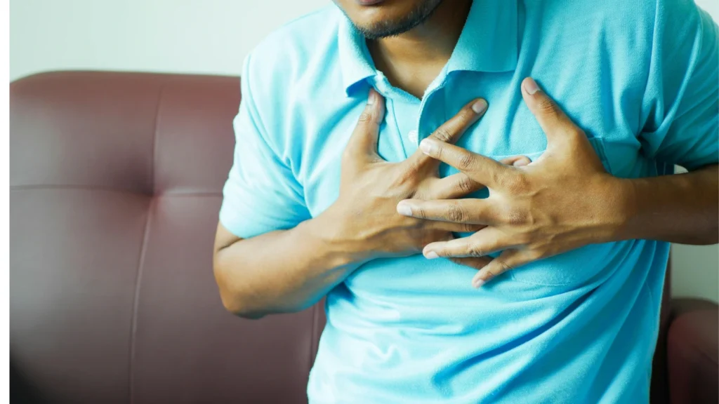 Man experiencing chest pain, possible sign of heart attack or heart disease📝 Caption (user-visible text):