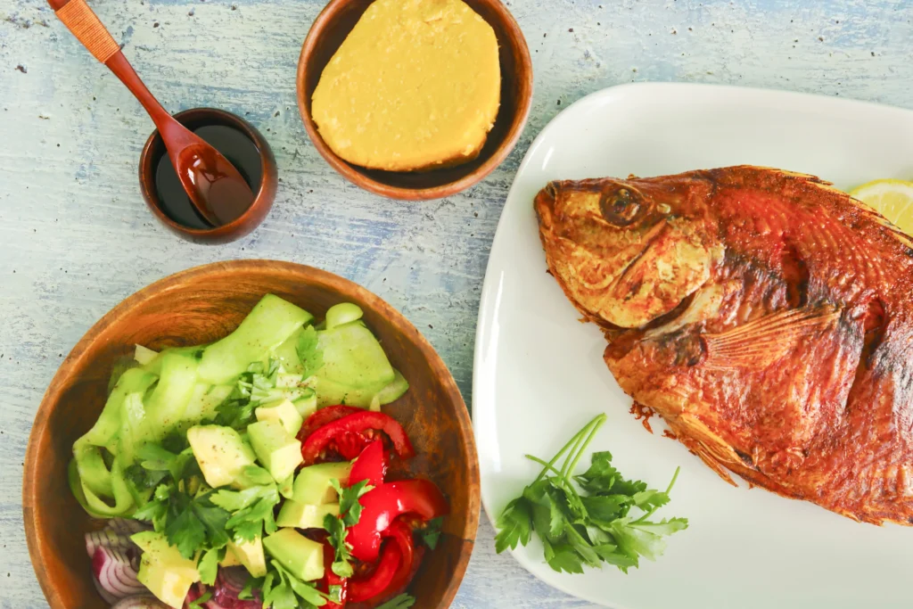 Healthy diet for fatty liver with grilled fish avocado salad and vegetables