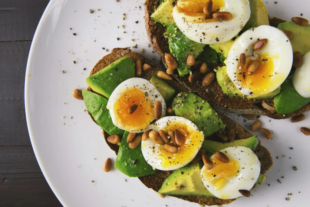 Vitamin D rich foods including boiled eggs and avocado on whole grain toast for deficiency management