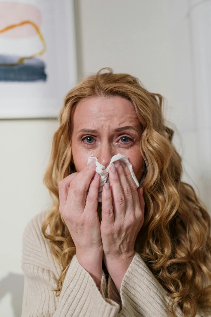 Woman with cold-like symptoms such as runny nose representing mild pneumonia vaccine side effects