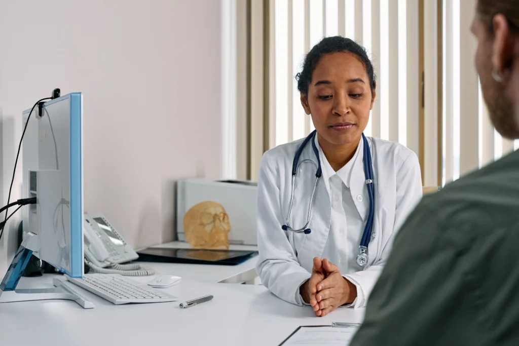 High blood pressure doctor consulting with a patient about blood pressure readings, hypertension diagnosis, and treatment.