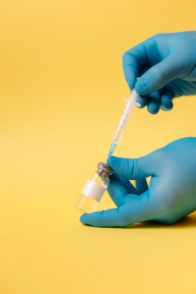 Healthcare professional preparing a Yellow Fever Jab vaccine injection before vaccination