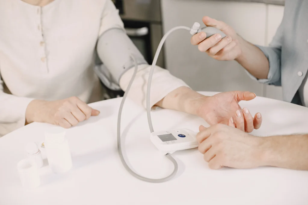 Healthcare professional checking blood pressure during a health screening for a high blood pressure supplements guide