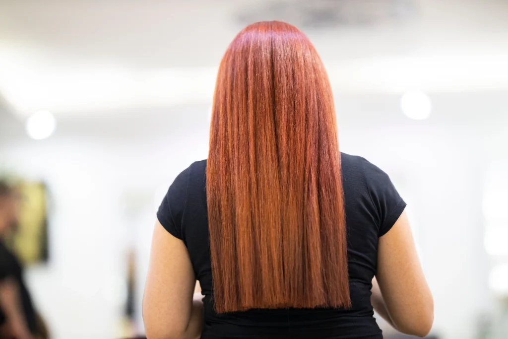 Long, smooth, shiny hair after a keratin treatment for hair care at a professional salon.
